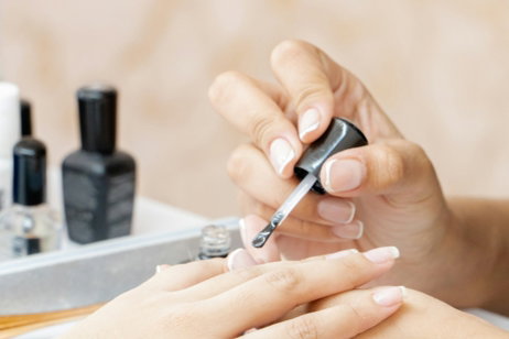 a woman is doing a manicure on a child's hand